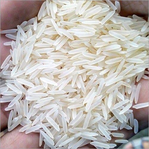 Long grain Indian rice held in a hand, ready for export